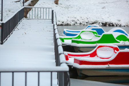 Boat in the park under the snow. Winter landscape. Snowfall.の写真素材