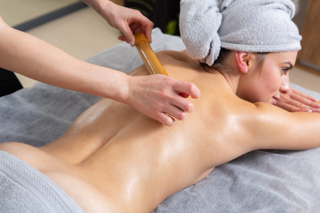 Woman having a back massage in spa salon. Beauty treatment concept.の写真素材