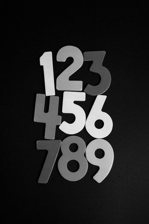 Numbers on a black background. White numbers on a black background.の写真素材