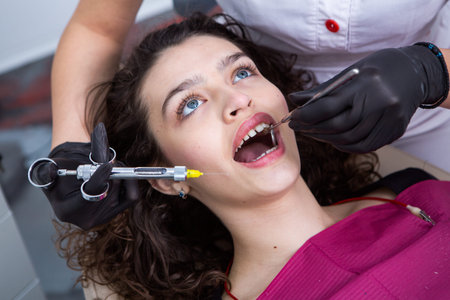 dentist and patient at the dental clinic, treatment of teeth