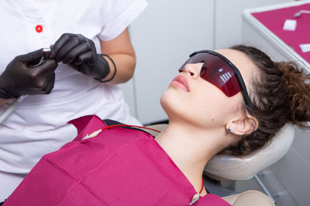 dentist and patient in the clinic of aesthetic cosmetologyの写真素材