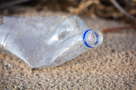 Plastic bottle on the beach. Pollution of the environment.