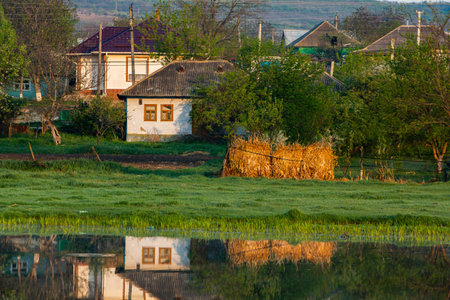 Village on the bank of the river in the morning light.の写真素材