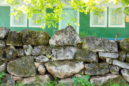 Old stone wall in the village. Ukraine, Europe. Selective focus.