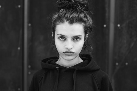 Portrait of a beautiful young girl in a black sweatshirt.の写真素材
