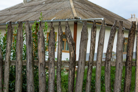 Old wooden fence and windows of a house in the village.