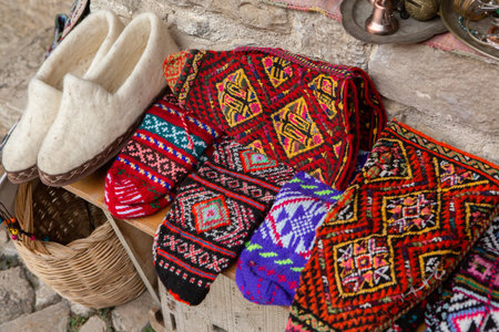Colorful handmade knitted sweaters and bags for sale in a souvenir shop. Beautiful and colorful traditional souvenirs from Albania.の写真素材