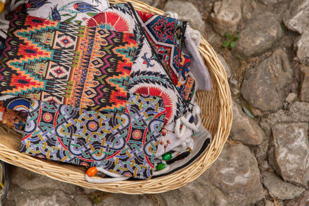 Colorful handkerchiefs in a basket on the street. Beautiful and colorful traditional souvenirs from Albania.の写真素材