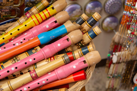 Colorful wooden flutes for sale in a souvenir shop.