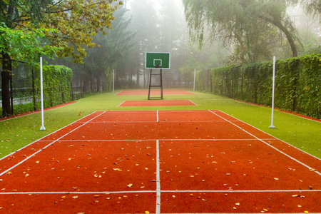 Empty tennis court in the morning mist, outdoor sport background concept.の写真素材