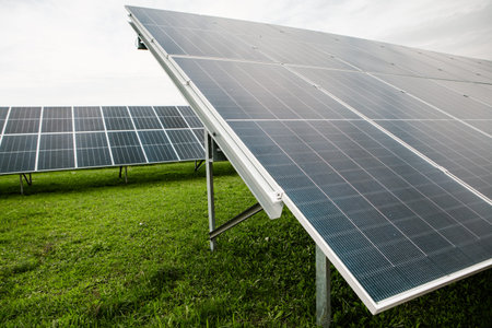 Solar panels on green grass field. Alternative energy source. Alternative energy concept.