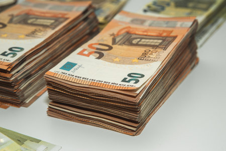 Euro banknotes on a white background. Shallow depth of field.の写真素材