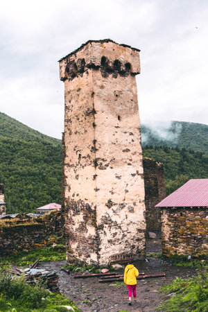 Little girl looking at the old tower.の写真素材