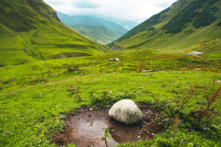 Mountain landscape with a small pond in the middle of the valleyの写真素材