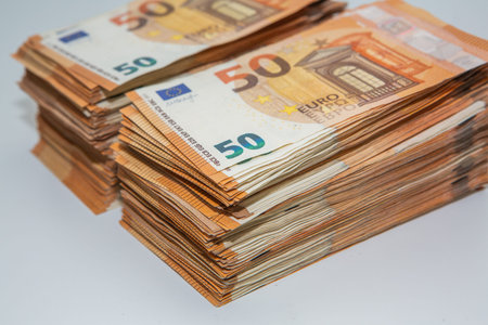 Pile of fifty euro banknotes isolated on a white background.