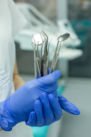 Dentist holding dental tools in a dental office, closeupの写真素材