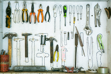 Set of hand tools and instruments for repair on white wall background.