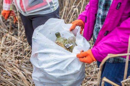 Plastic bag with garbage in the hands of children. The concept of environmental pollution.