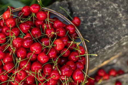 Cherries in a bowl on a wooden background. Top view.の写真素材