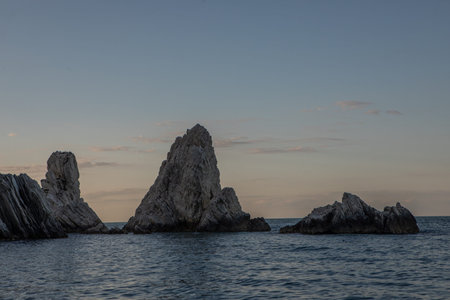 Beautiful panoramic view of rocky coastline and ocean horizon at sunset.