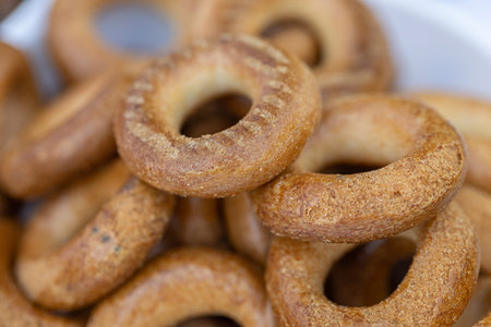 Close up of bagels in a white bowl on a market stall