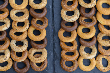 Different types of bagels on a black background. Top view.