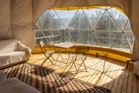 Interior of a tent with a view from the window to the nature