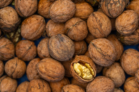 Walnuts in a basket on a market stall, close-upの写真素材