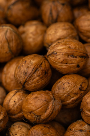 Close up of a pile of walnuts. Whole walnuts background.の写真素材