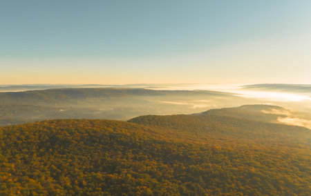 Aerial view of foggy morning in the mountains. Beautiful nature landscape background