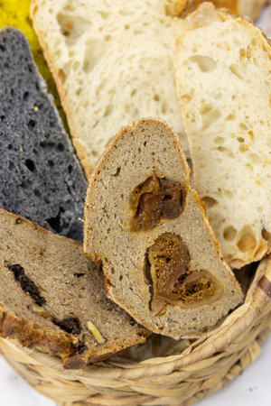 Slices of bread with raisins in a basket.の写真素材