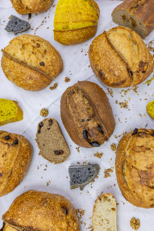 Slices of bread with raisins and poppy seeds on a white background