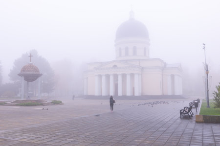 Sunrise over the calm autumn streets of Chisinau Republic of Moldova surrounded by fogの写真素材