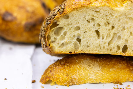 Freshly baked bread on a white wooden table. Selective focus.