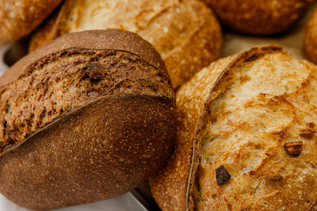 Different types of bread on a wooden background. Close-up.