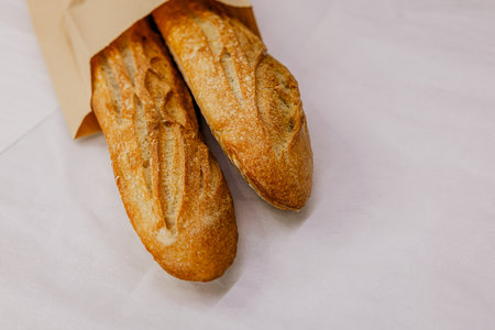 French baguettes in a paper bag on a white background.の写真素材