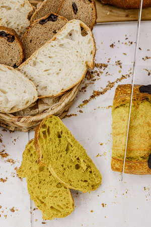 Freshly baked bread in a wicker basket on a white background