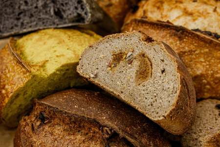 Assortment of baked bread on wooden table background. top view.