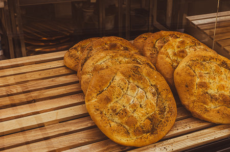 Freshly baked bread on a wooden table in a bakery. Toned.の写真素材
