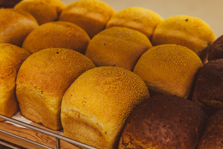 Freshly baked buns on display in a bakery. Close up.の写真素材