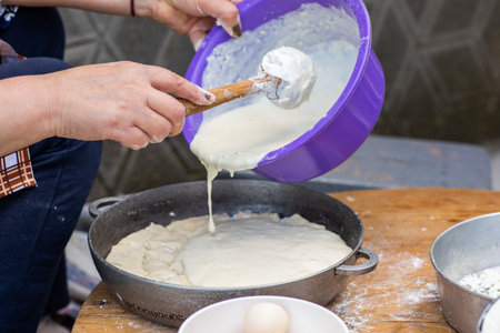Rural Moldovan Grandma Preparing Traditional Homemade Cheese Pastry. Authentic Village Cooking....
