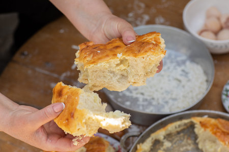 Rural Moldovan Grandma Preparing Traditional Homemade Cheese Pastry. Authentic Village Cooking....