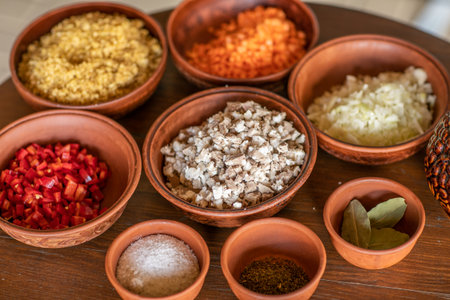 spices and herbs in clay bowls on a wooden table close-upの写真素材