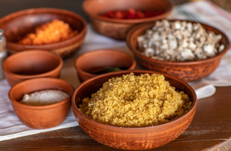 Couscous in clay bowls on a wooden table, close-upの写真素材