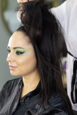 A model getting ready backstage for the Fall/Winter 2019 collection during New York Fashion Week at...