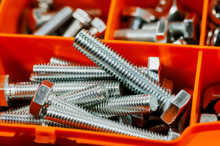 Screws and nuts in a box close-up macro photo