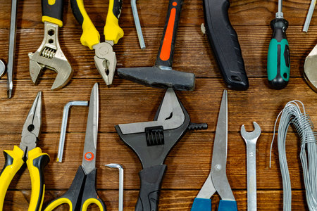 Variety of tools on wooden background. Top view. Copy space.