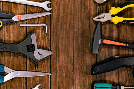 Variety of tools on wooden background. Top view with copy space