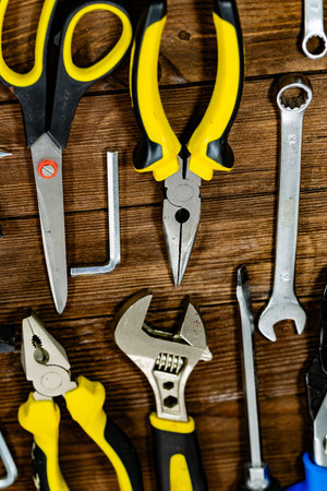 Variety of tools on wooden background top view copyspace.