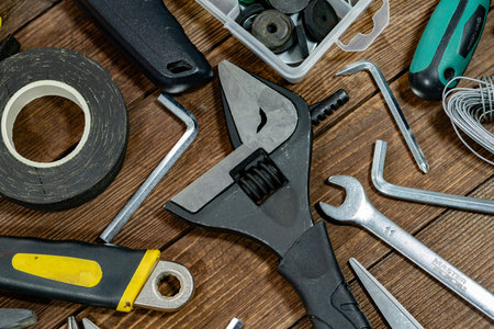 Variety of tools on wooden background. Top view. Copy space.